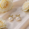 Crystal Bow Pearl Drop Earrings – Gold Plated Statement Studs